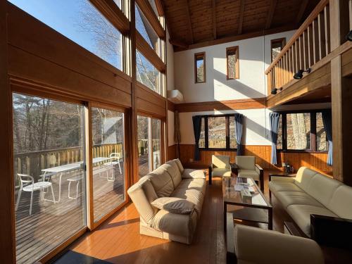 a living room with a couch and a table at Cabin B vacation house rental Mt Fuji View 3 min lake Saiko 5min drive Lake Kawaguchi in Fujikawaguchiko