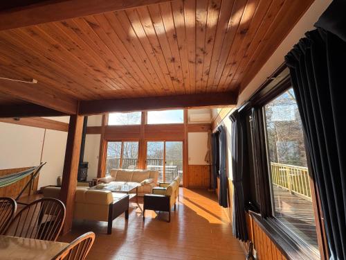 a living room with a couch and a table at Cabin B vacation house rental Mt Fuji View 3 min lake Saiko 5min drive Lake Kawaguchi in Fujikawaguchiko