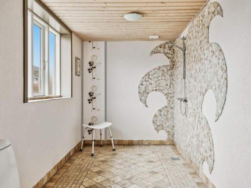 a bathroom with a shower and a stool in a room at Expansive Villa near Ribe in Skærbæk
