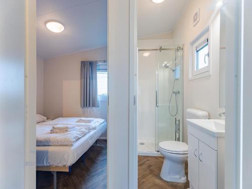 a bathroom with a bed and a shower and a toilet at Bright Beachside Base in Burgh-Haamstede in Burgh Haamstede