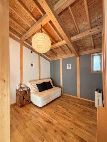 a bedroom with a bed and a wooden floor at Tiny House - Vacation STAY 12059v in Ōtakuchi