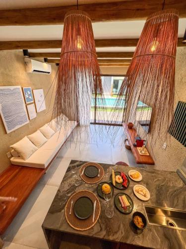 a room with a table with plates of food on it at Brisa e Sal in São Miguel dos Milagres