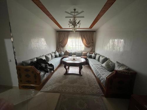 a living room with a couch and a table at maison achab in Asilah