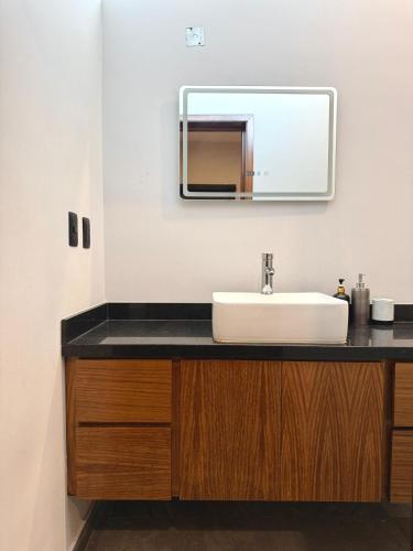 a bathroom with a sink and a mirror at Comfort stay Mazatlan in Mazatlán