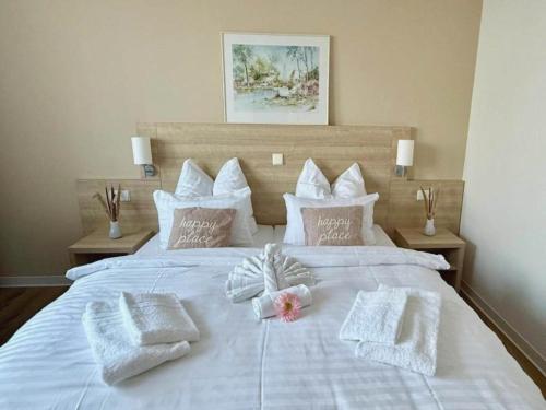 a white bed with towels and pillows on it at Kaiserhof Feldberg- Standard Double Room in Feldberg