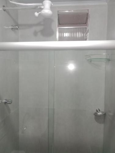 a bathroom with a shower and a glass door at Pousada e Hostel Campo in Vespasiano