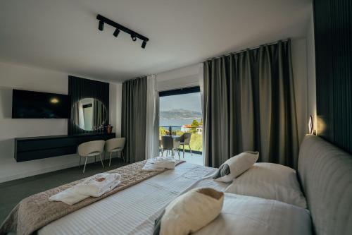 a bedroom with a large bed and a large window at SEAPHORIA Luxury Modern Villa in Trogir