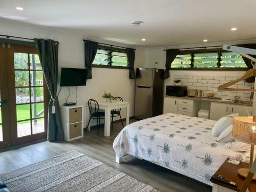 a bedroom with a bed and a kitchen with a table at Horseshoe Haven in Horseshoe Bay