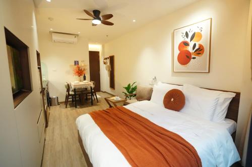 a hotel room with a bed and a dining room at Hanoi Aurelia Stay in Hanoi