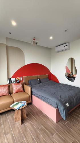 a bedroom with a bed and a couch at 4Chan Phúc Đồng Apartment in Hanoi