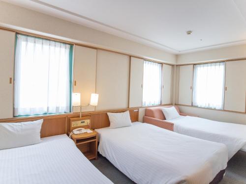 Giường trong phòng chung tại Hotel Belleview Nagasaki Dejima