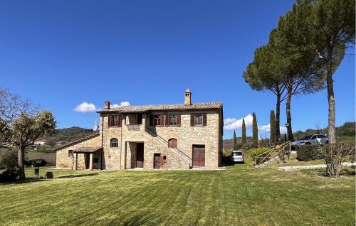 an old stone house with a grass yard at Umbria Magione Podere C in Magione