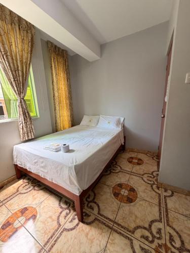 a small bedroom with a bed and a window at Hotel Prince in Barranca