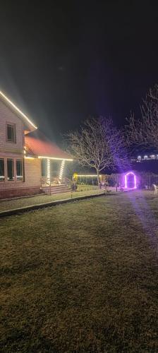 a house with lights in a yard at night at Birdsong pahalgam in Pahalgām