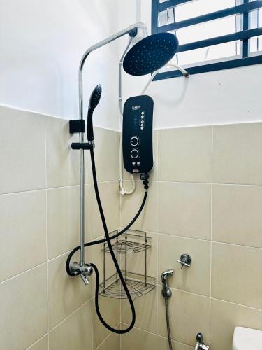 a shower with a blow dryer in a bathroom at The Luxe Permata by Haffa in Lunas