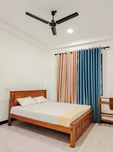a bedroom with a bed and a ceiling fan at NRS Villa Midigama in Midigama East