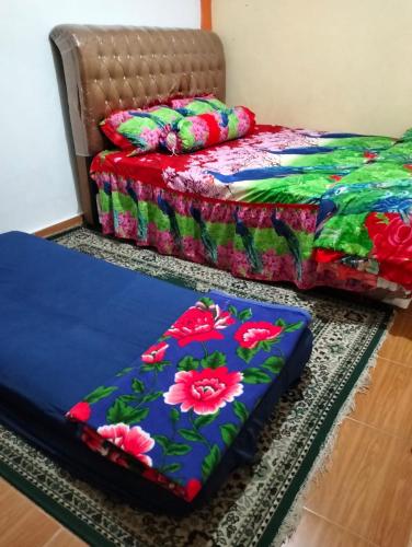 two beds sitting on the floor in a room at KHAIRI HOMESTAY in Bukittinggi