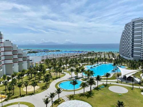 an aerial view of a resort with a pool and palm trees at ARENA JKV condotel in Nha Trang