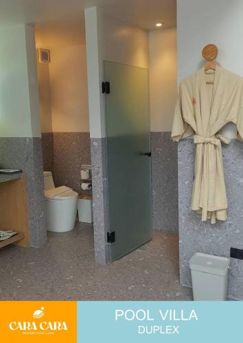 a robe hanging on a wall in a bathroom at cara cara resort in Ko Larn