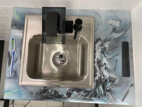 a stainless steel sink in a plastic container at Tree Star Motel in Monroeton