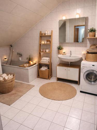 a bathroom with a sink and a washing machine at Luxury Rhine Retreat Garten&Sauna in Busingen am Hochrhein