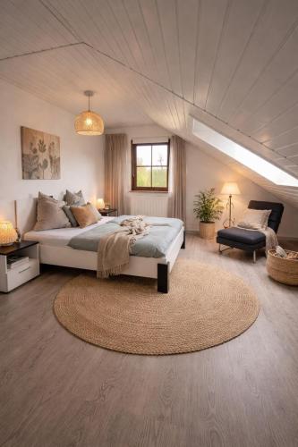 a large bedroom with a bed and a rug at Luxury Rhine Retreat Garten&Sauna in Busingen am Hochrhein