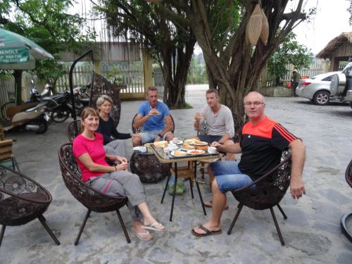 a group of people sitting around a table at Chez Loan Hotel in Ninh Binh
