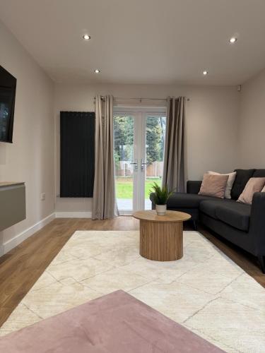 a living room with a couch and a table at Middleton Mews- 3BR- Wollaton Park-Hospital & Uni in Nottingham