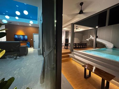 a house with a swimming pool and a living room at บลูด้าพูลวิลล่าซี Bludapoolvilla C in Ban Khlong Toei (1)