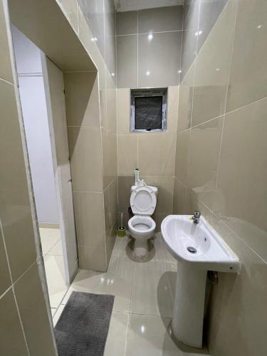 a small bathroom with a toilet and a sink at Davidson Lodge in Goodwood