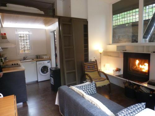 a living room with a fireplace and a kitchen at Apartment Rovellada Platja in Colera