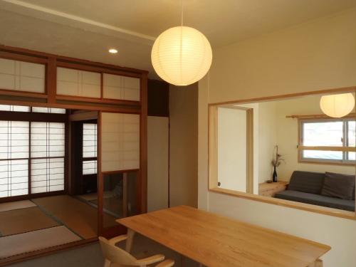 a dining room with a table and a mirror at HITOYANE guesthouse-1日1組限定- in Aizuwakamatsu