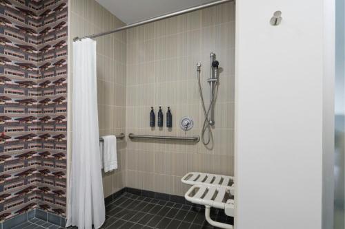 a shower with a shower curtain in a bathroom at Aloft by Marriott Richmond West Short Pump in Short Pump