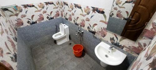 a bathroom with a sink and a toilet and a urinal at K Apartment in Varkala
