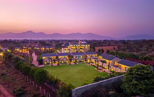 an aerial view of a mansion at dusk at Merriment Luxury Resort & Private Pool Villa Near Mount Abu, Abu Road in Bhīmānia