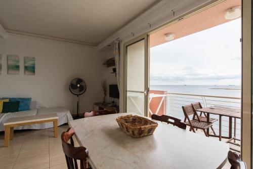 a living room with a table and a view of the ocean at SeaFront Apartment Marsascala in Marsaskala