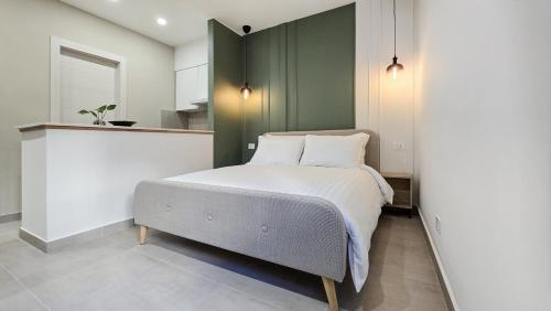 a bedroom with a bed with a green headboard at MASA 2Rooms in Piazza Armerina