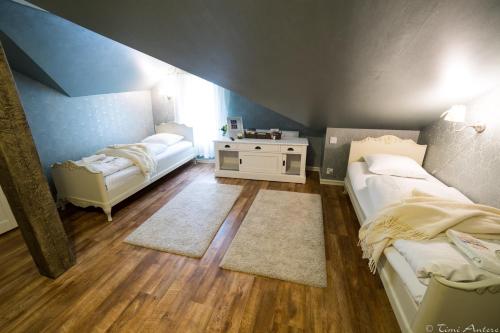 a room with two beds and a table in it at Vaihmalan Hovi in Lempäälä