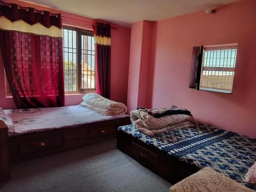 due letti in una stanza con pareti e finestre rosse di Silwal Home a Kathmandu