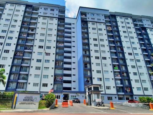 a large white apartment building with balconies at D Kristal Apartment in Semenyih