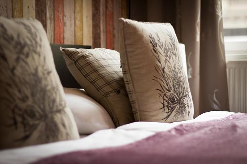 a couple of pillows sitting on a bed at Royal Court Legerova in Prague