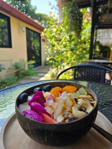 a bowl of vegetables sitting on a table at The Old City Rooms in Chiang Mai