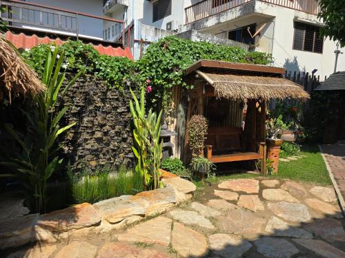 a small building with a bench in a yard at The Old City Rooms in Chiang Mai