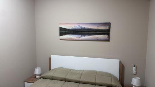 a bedroom with a bed and a picture on the wall at Angel house airport in CTA