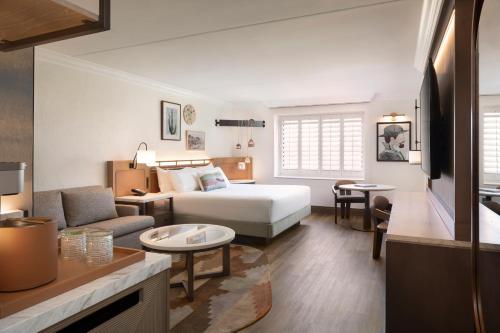 a hotel room with a bed and a living room at The Scottsdale Resort & Spa, Curio Collection by Hilton in Scottsdale