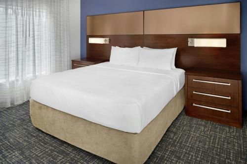 a large bed in a hotel room at Residence Inn by Marriott Charlotte Airport in Charlotte