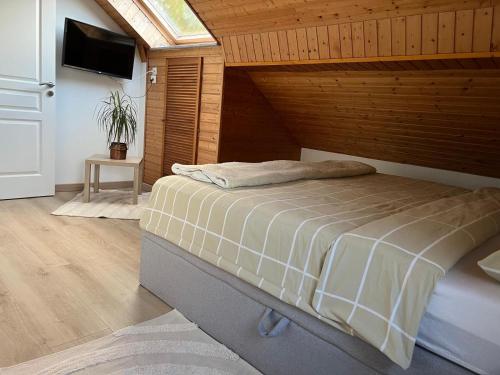 a bedroom with a bed in a room with a window at Gite Les Hirondelles in Langatte