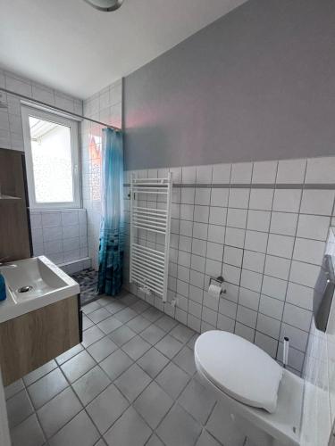 a bathroom with a toilet and a sink at Haus Waterkant in Breege