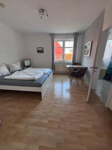 a bedroom with a bed and a table and a window at Haus Waterkant in Breege