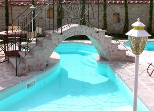 a small swimming pool with a staircase and a stair case at Monastery Birbino in Le Ville